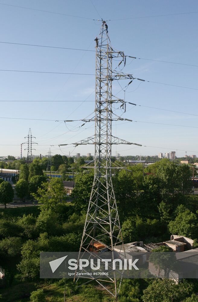 Worker executing repairs at power transmission lines