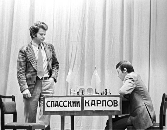 Russian chess grandmasters Boris Spassky, right, and Anatoly Karpov, left,  shake hands the news