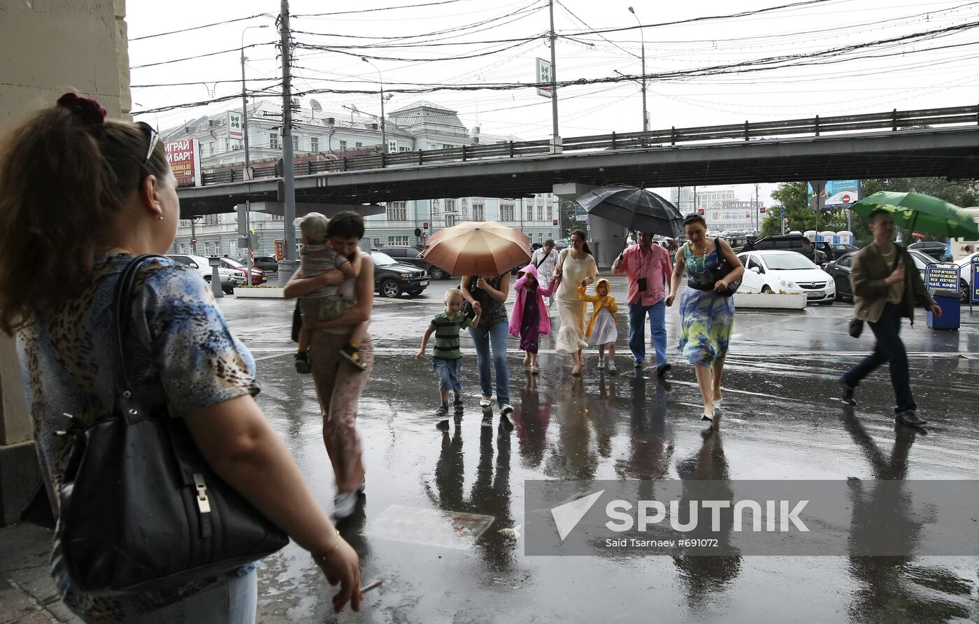 Pedestrians walking in rain