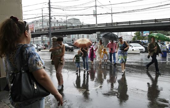 Pedestrians walking in rain