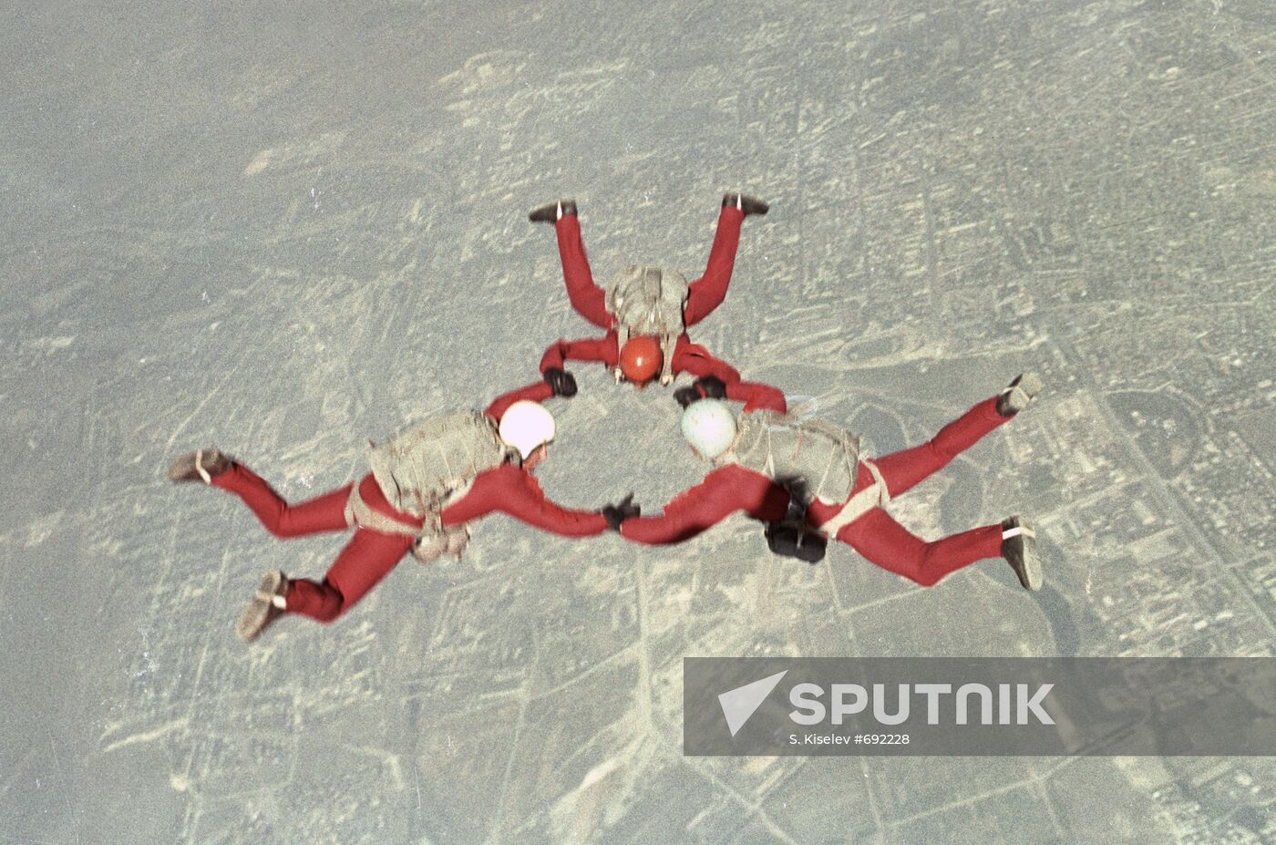 Skydivers perform figure in the sky