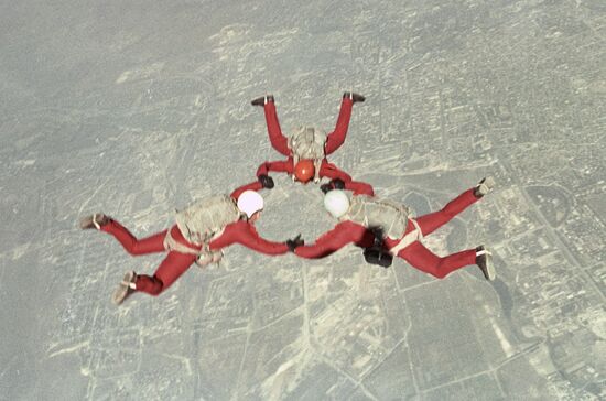 Skydivers perform figure in the sky