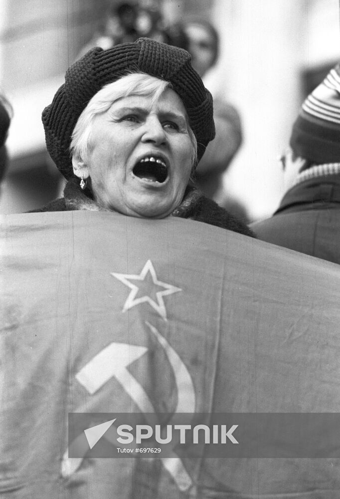 Participant in the rally with the banner of the former USSR