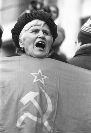 Participant in the rally with the banner of the former USSR