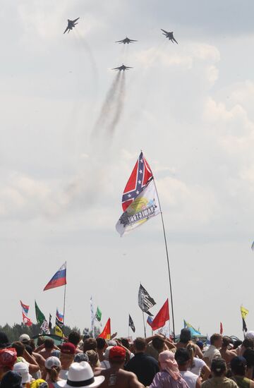 Music fans watch air show at Nashestviye 2010 rock festival