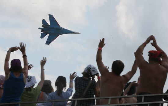 Music fans watch air show at Nashestviye 2010 rock festival