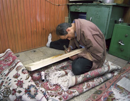 Young people weaving expensive carpets