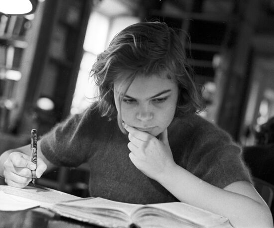 Young woman at library reading room