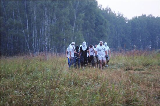 Masked persons in Khimki forest