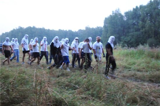 Masked persons in Khimki forest