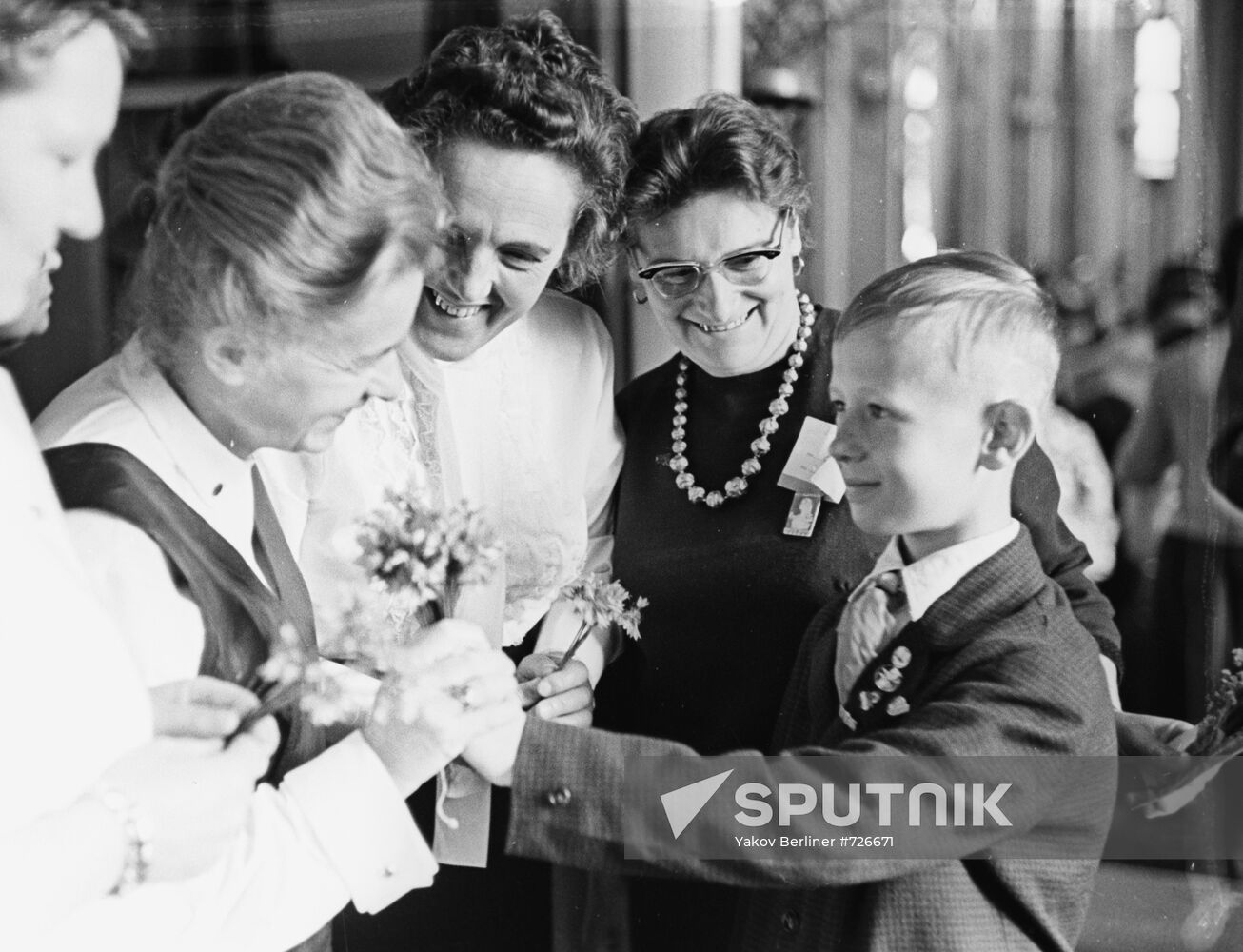 Pioneer Viktor Kosykh giving flowers to delegates of the Moscow World Women's Congress