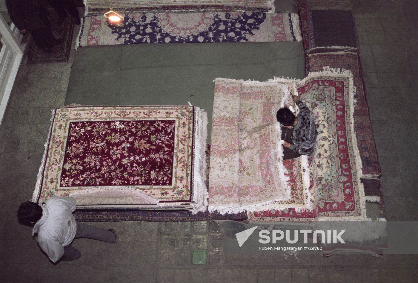 Teenagers weaving expensive carpets