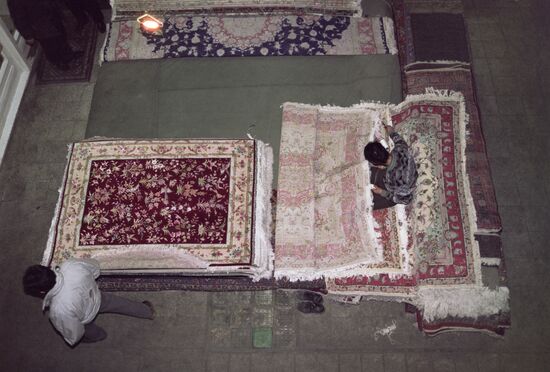 Teenagers weaving expensive carpets