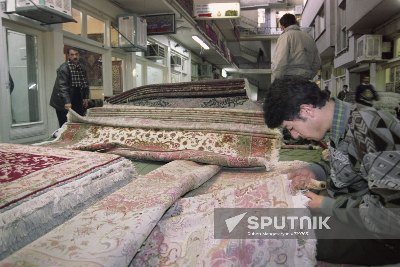 Teenagers weaving expensive carpets