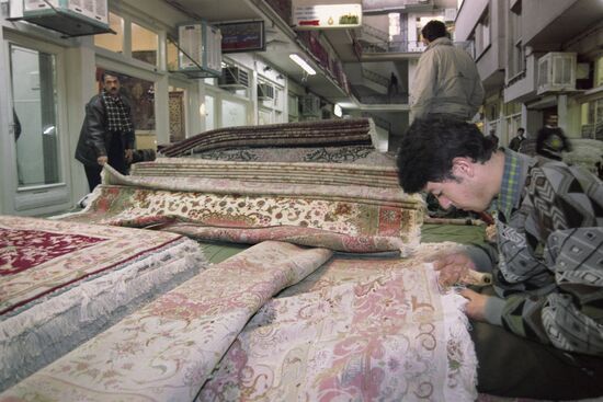 Teenagers weaving expensive carpets