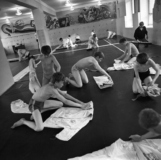 Boys folding their uniforms after training