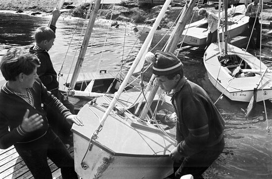 Boys setting yacht afloat