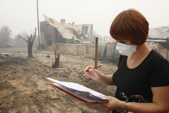 Making list of burned buildings in village of Borkovka