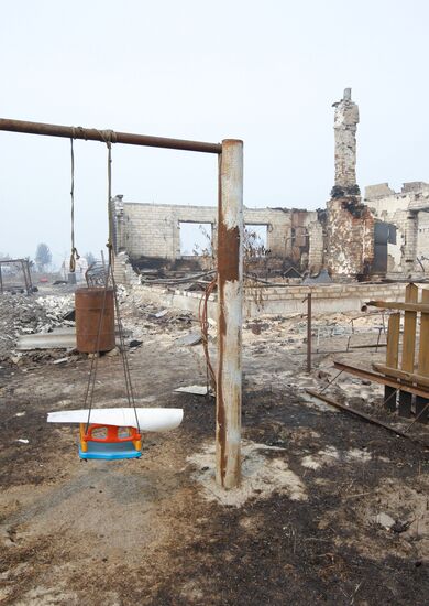 Aftermath of fire in village of Krasny Bakin
