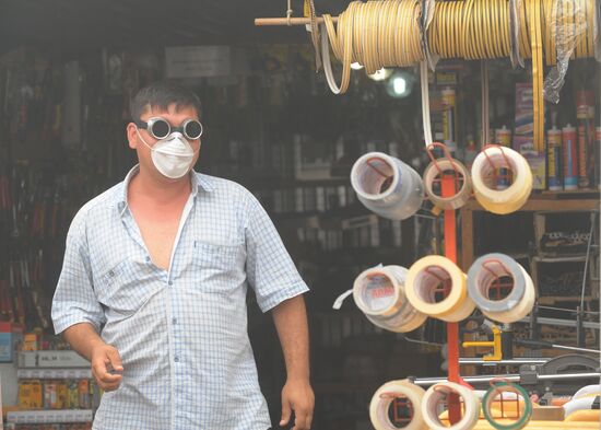 Marketplace vendor wearing a mask