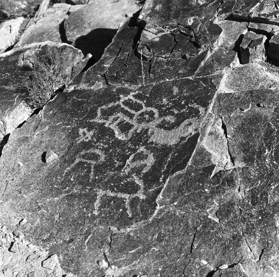 Ancient rock painting "Man and Goats"
