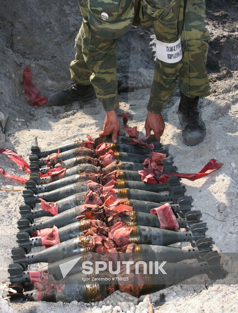 Bomb expert arranges munitions to be disposed