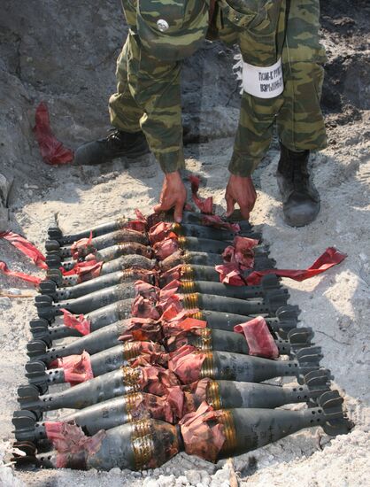 Bomb expert arranges munitions to be disposed