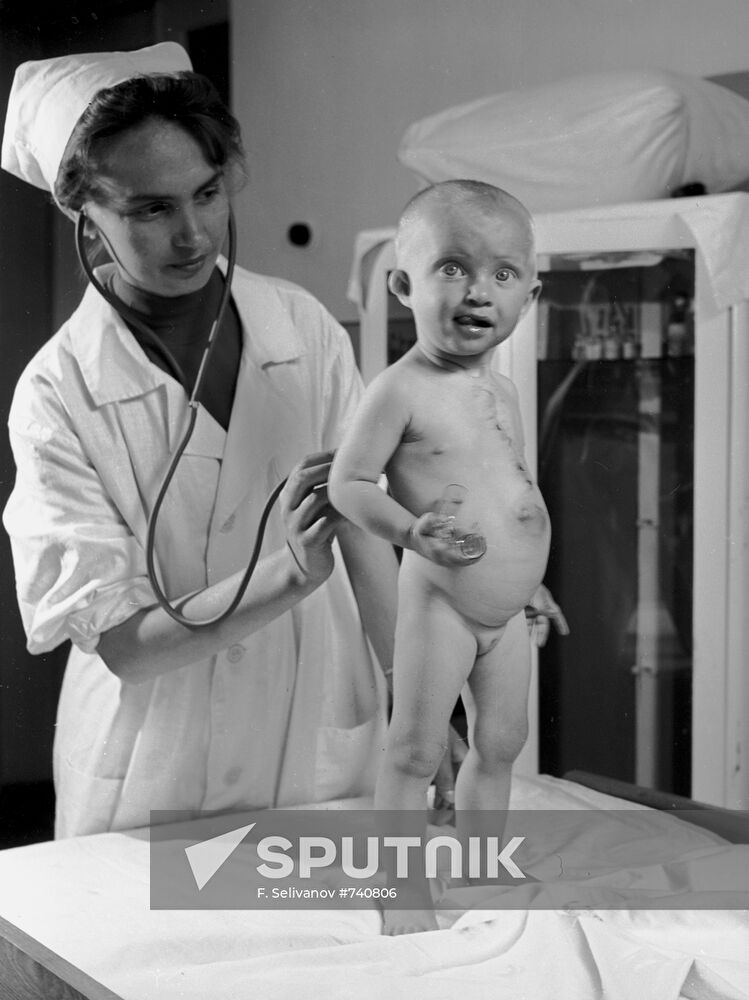 Pediatrician examining baby