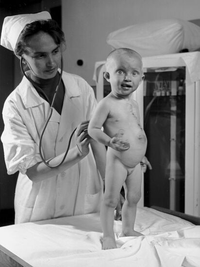 Pediatrician examining baby