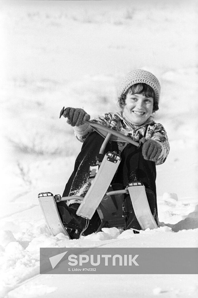 Girl on snow scooter