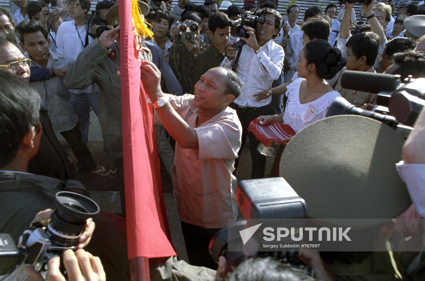 Heng Samrin attaching order to flag