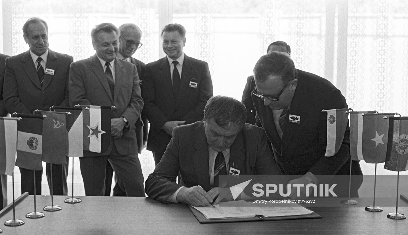 Mikhail Shchadov signing protocol of CMEA commission meeting