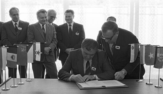 Mikhail Shchadov signing protocol of CMEA commission meeting