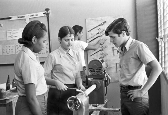 Cuban schoolchildren in carpenter's workshop