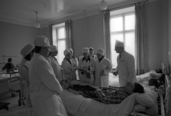 Doctors in patient room while doing rounds