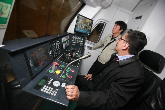 Train driver and assistant driver in train cabin