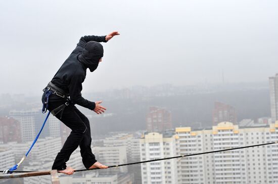 Athletes walk on wire rigged 25 meters above ground