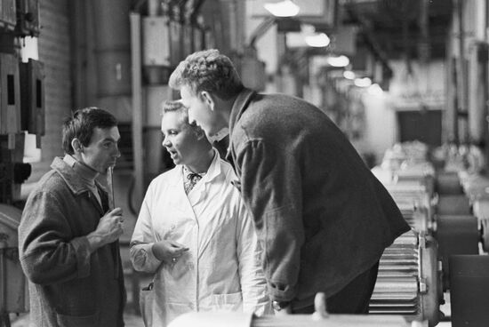 Factory's doctor talking to workers