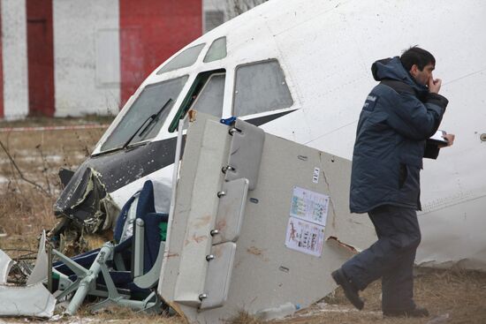 Investigators work at the site of emergency landing of Tu-154
