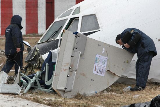 Investigators work at the site of emergency landing of Tu-154