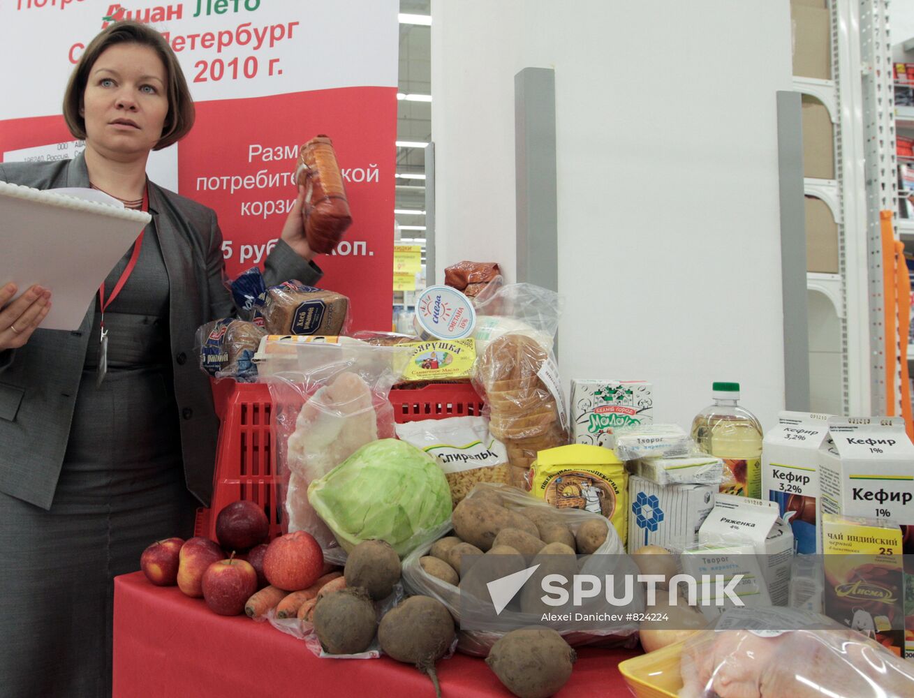 Hypermarket manager with goods of consumer basket