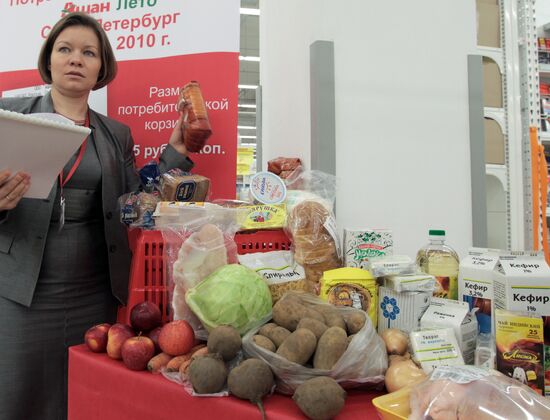 Hypermarket manager with goods of consumer basket
