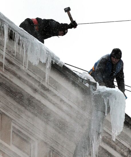 Communal services officers clear roofs of icicles