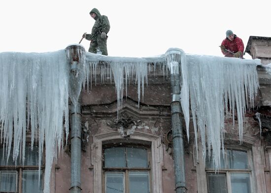 Communal services officers clear roofs of icicles