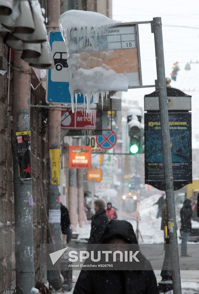 Icicles hang from bus stop signboard