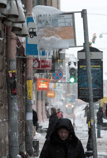 Icicles hang from bus stop signboard