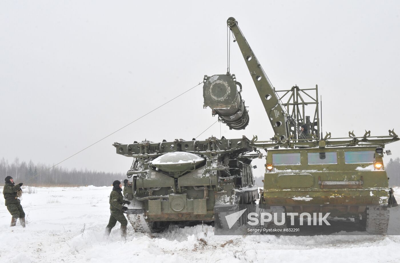 Staff reload a missile to launcher of air defense system C-300B