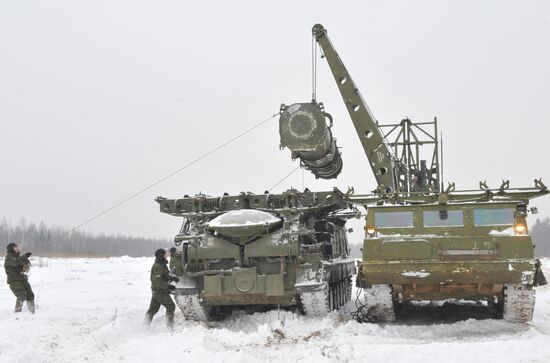 Staff reload a missile to launcher of air defense system C-300B