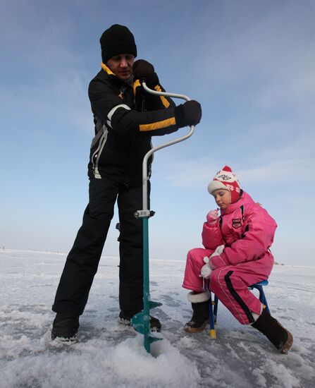 Winter fishing on the ice of the Amur bay near Vladivostok