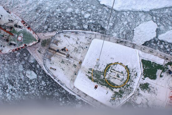 Icebreakers leading out ice-trapped ships in Sea of Okhotsk